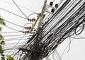 Messy electrical cables in thailand - Uncovered optical fiber technology open air outdoors asian cities Royalty Free Stock Photo
