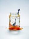 Messy jar of homemade apricot preserves with spoon Royalty Free Stock Photo