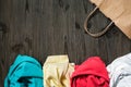 Messy folded clothes and a paper bag Royalty Free Stock Photo