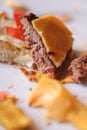 Messy food leftovers. Burger leftover on the plate after party Royalty Free Stock Photo