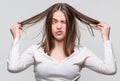 Messy hair. Brunette woman with messed hairs. Girl having a bad hair. Bad hairs day. Frustrated woman having a bad hair Royalty Free Stock Photo