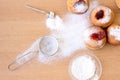 Messy Hanukkah table with sugar powder and doughnuts