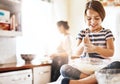 Messy, happy and child baking in the kitchen with parent for bonding, food and dessert. Funny young girl mixing flour in Royalty Free Stock Photo