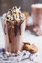 Hot chocolate, cream and marshmallows and a choc-chip cookie Royalty Free Stock Photo