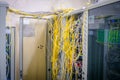 Messy internet wires have a connection to computer servers. Cabinets with computer equipment are located in the data center. Racks Royalty Free Stock Photo