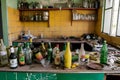 Messy kitchen with various bottles of alcoholic beverages, AI-generated. Royalty Free Stock Photo