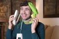 Messy man using two landline telephones at the same time Royalty Free Stock Photo