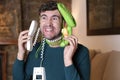 Messy man using two landline telephones at the same time Royalty Free Stock Photo