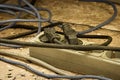 Messy outlet power extension cord on an apartment floor with plugs plugged in. Cable power cords in a tangled mess on