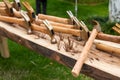 A messy pile of rusty nails and hammers on a wooden board Royalty Free Stock Photo