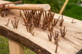 A messy pile of rusty nails and hammers on a wooden board Royalty Free Stock Photo