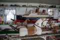 Messy room of vintage American wooden rocking horses and old American toys