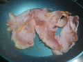 Messy strips of cooked ham in a pan