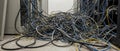 Messy tangled server room cables lying on floor Royalty Free Stock Photo