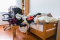 Messy teenager room. Untidy cluttered bed, dirty clothes