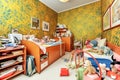 A messy and tidy child\'s bedroom with all kinds of things scattered on the floor Royalty Free Stock Photo