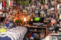A messy and tidy teenage boys bedroom with all kinds of things scattered on the floor