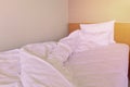 Messy unmade bed with pillow and quilt cover Royalty Free Stock Photo