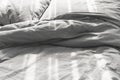 Messy unmade bed with two pillows, gray bed linen Royalty Free Stock Photo