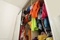 Messy wardrobe with clothes, low angle view. Fast fashion concept