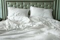 Messy White Bed Sheets and Pillow in the Morning Royalty Free Stock Photo