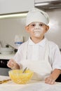 Messy young boy preparing to bake