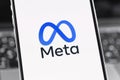 Meta logo on the screen smartphone, iPhone closeup