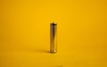metal AAA battery on a yellow background Royalty Free Stock Photo