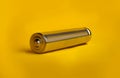 metal AAA battery on a yellow background close-up Royalty Free Stock Photo