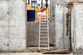 Metal aluminum ladder or ladder at a construction site in the basement of a concrete monolithic house Royalty Free Stock Photo