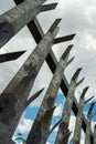 Metal anti climbing fence with spikes on top grey color. Safe perimeter of property. Blue cloudy sky. Nobody. Security and Royalty Free Stock Photo