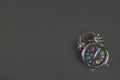 Metal antique alarm clock on black background with space for text. Back to school concept. Flat lay, Top view