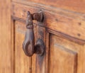 Metal antique door handle on old rusty brown door close view Royalty Free Stock Photo