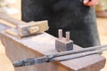Metal anvil, hammer and tongs for blacksmith working