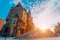 Metal arch bridge and old red bricks building in the Speicherstadt warehouse district of Hamburg HafenCity with sunburst