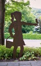 Metal Artwork Display of a little school girls with basket and butterfly.
