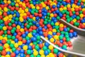 Metal baby slide going down to the pool with many colored balls in the kids playing room Royalty Free Stock Photo