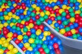 Metal baby slide going down to the pool with many colored balls in the kids playing room Royalty Free Stock Photo
