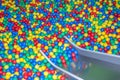 Metal baby slide going down to the pool with many colored balls in the kids playing room Royalty Free Stock Photo