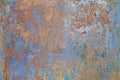 Close-up of a metal or steel plate, covered with old paint. Cracking and flaking paint on rusty iron background. Royalty Free Stock Photo