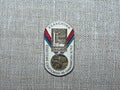 Metal badge with the image of the Olympic medal and the inscription `Soviet athletes at the Olympics, Helsinki-1952`