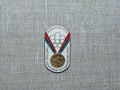 Metal badge with the image of the Olympic medal and the inscription `Soviet athletes at the Olympics, Montreal-1976`