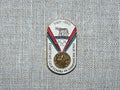 Metal badge with the image of the Olympic medal and the inscription `Soviet athletes at the Olympics, Rome-1960`