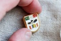 Metal badge with mexican flag, word MEXICO, sombrero and poncho on it