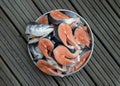Metal baking tray filled with Large pieces of fresh raw atlantic salmon and Fresh salmon head
