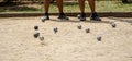 Metal ball from the game of petanque approaching the bowling alley bouncing off the sandy ground raising dust from a petanque Royalty Free Stock Photo