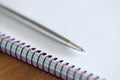 Metal ballpoint pen lying on blank notebook closeup Royalty Free Stock Photo