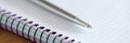 Metal ballpoint pen lying on blank notebook closeup Royalty Free Stock Photo