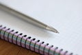 Metal ballpoint pen lying on notepad closeup Royalty Free Stock Photo