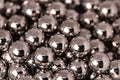 Metal balls arranged side by side to form an organized structure. Macro scale photo with shallow depth of field. Glossy surface Royalty Free Stock Photo